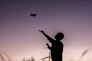 silhouette of a person with drone against the sky. silhouette of a person in a field. silhouette of a person in the sunset. silhouette of a person.