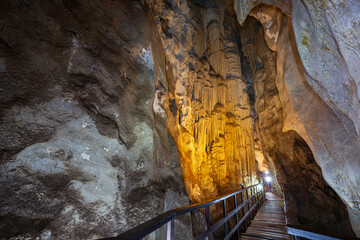 Walkway inside the scenic, illuminated and narrow Diamond Cave (Tham Phra Nang Nai) in Railay, Krabi, Thailand.