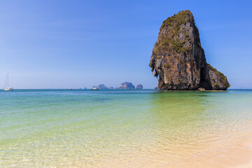 Stunning landscape of a tall limestone cliff, blue sky and turquoise sea at the Phranang (Phra...