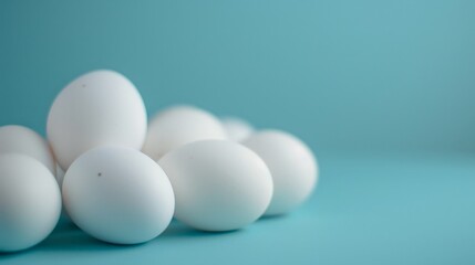 A pile of white eggs against a blue background.