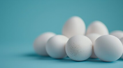 A pile of white eggs on a blue background