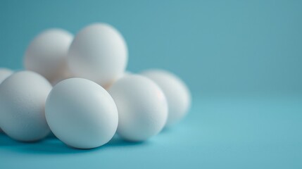 A pile of white eggs on a blue background