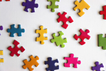 Colorful jigsaw puzzle pieces on white background. Flat lay.
