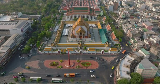 An aerial view of Red Giant Swing and Suthat Thepwararam Temple at sunset scene, The most famous tourist attraction in Bangkok, Thailand.