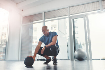 Workout, black man and fitness ball in gym for strength, training and wellness for healthy balance....