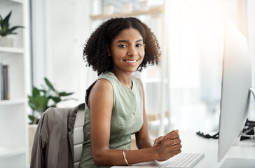 Black woman, portrait and computer in office with smile as web designer for market research,...