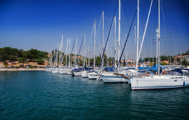 Obraz premium Coastal town and marina with boats and clear blue sky. European travel and vacation concept