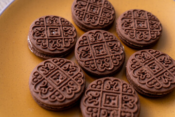 Close-up of cream-filled chocolate biscuits on a plate