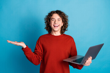 Photo of funky excited guy dressed red pullover reading modern gadget holding arm emtpy space...