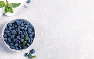 organic blueberries in bowl on gray background
