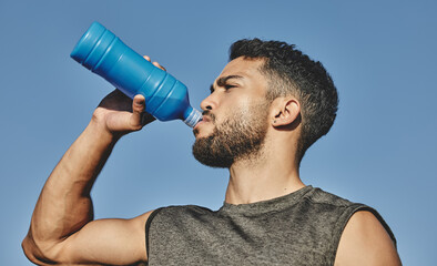 Man, water bottle and drink with blue sky in nature, outside and hydration for exercise and...