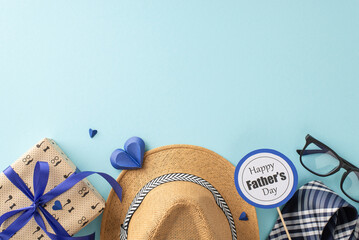 Personalize your Father's Day message with a top-view arrangement highlighting a straw hat, elegant necktie, gift box, glasses, postcard, and paper hearts on a soothing pastel blue scene