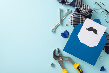 Top view of thoughtful Father's Day offerings exhibit vital tools, adjustable wrench, screw, nuts, refined necktie, envelope with themed postcard, glasses, and hearts on light blue backdrop