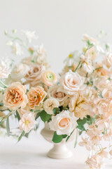 Obraz premium Flower arrangement of white and pink roses and peonies in vintage vase.