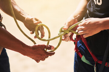 Naklejka premium Rock climbing, adventure and hands of people with rope for training, exercise and outdoor extreme sports. Nature, travel and friends with harness, equipment or gear for fitness, workout and challenge
