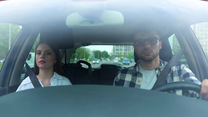 Scared young couple driving a car while getting drive accident while screaming during the collision. Stressful traffic. Transport, travel, relationships, safety concept. Real time