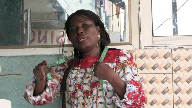 close-up of a beautiful seamstress woman with a measuring tape.