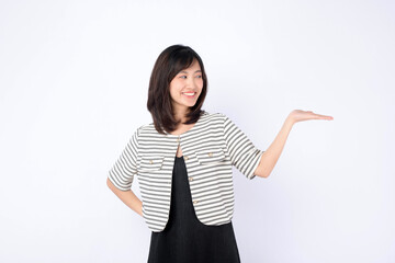 Asian woman is gesturing with her hand to showing a product against a white background.