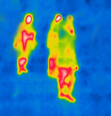 Passers-by, people walking along the evening street. Image from thermal imager device.