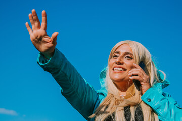 girl with mobile phone waving