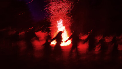 Huge fire at night and young people around. Pagan festival of Walpurgis night: bonfires, dancing wildly, witches. Figure of Witches Queen (HexenkР“В¶nigin). German legends, St. Walburgas and Satanism