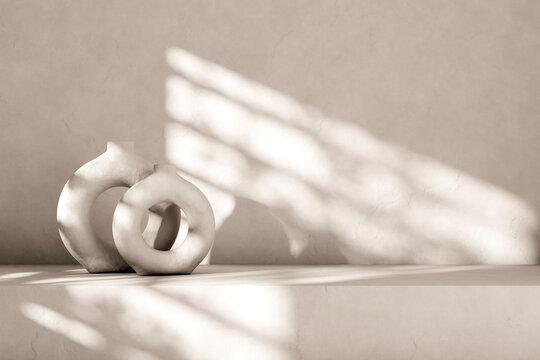 White interior design with nordic ceramic vase and sunlight from the window. Empty room background with minimal aesthetic decor.