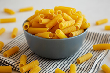 Dry Rigatoni Pasta in a Bowl, side view.