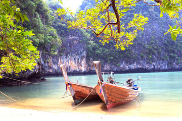 Traditional wooden longtail boat were parking on the beach in Phuket, Thailand