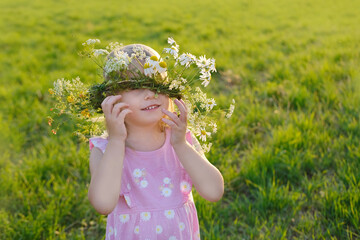 floral crown adorns head child, happy girl in wreath, floral crown, green sunlit meadow, beauty...