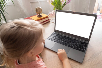 preschool girl studying distance learning course, using computer, monitor with white screen mockup,...