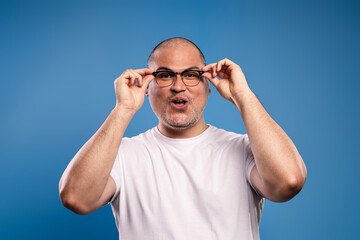 man holding his prescription glasses