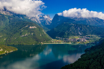 Aerial View of Lago di Molveno in Trentino, Italy, Scenic Alpine Lake with Lush Surroundings and Vibrant Beach