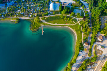 Aerial View of Lago di Ledro with Vibrant Turquoise Waters, Lush Greenery Along Lakeside in Italy