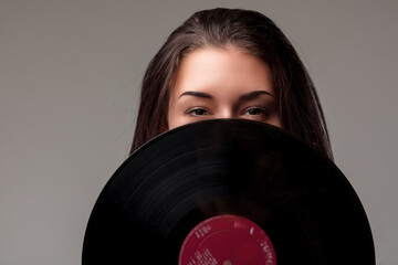 oyous gaze emerges above vintage vinyl LP