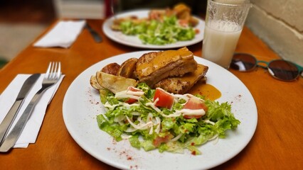 salad on a plate with healthy pork ribs