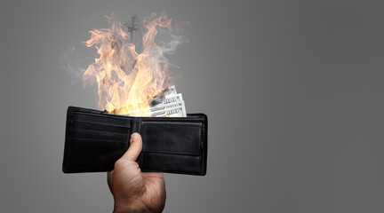 Dollar banknotes burning in flames and smoke showing inflation and money loss concept
