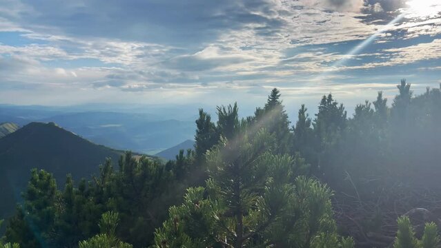 Picturesque landscape with unique sun ray barking through the clouds over the Mala Fatra mountain range, Zilina region, Slovakia. Beauty in Nature concept 4K footage.