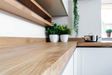 Close-up of a kitchen countertop with a wooden surface and white cabinets. A closeup of a wood countertop in a modern minimalist style interior design. A closeup of an oak furniture piece on the wall