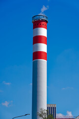 Looking up concrete red and white striped concrete chimney of district heating at Swiss City of Z&uuml;rich on a sunny spring noon. Photo taken May 10th, 2024, Zurich, Switzerland.
