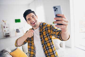 Photo of cool good mood man wear checkered shirt tacking selfie pointing finger modern device...