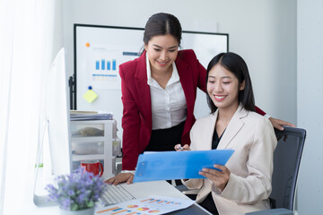 Happy Asian smiling businesswoman working together in office