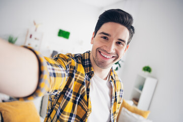 Photo of cool good mood man wear checkered shirt staying home tacking selfie indoors house...