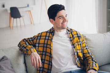 Photo of funky thoughtful man wear checkered shirt staying home sitting couch indoors house...