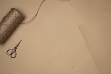 Sheets of paper background with string and scissors. Vintage. Flat lay, top view. Copy space