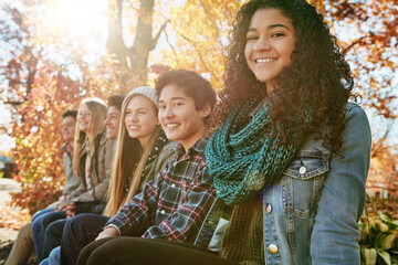 Portrait, smile and group with autumn, park and nature for college break and bonding. Friends,...