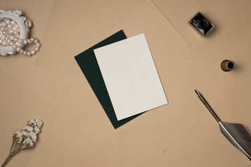Empty white paper list with old accessories in vintage style on sheets of paper background from above. Copy space