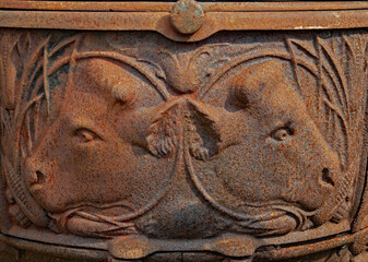 cow faces on rusty iron coal or wood stove