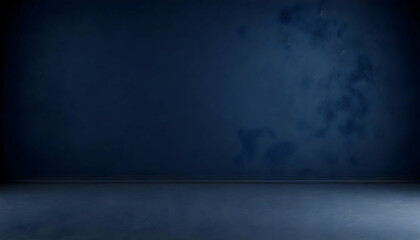 Dark blue wall in an empty room with a concrete floor.