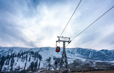 Snow covered mountain range with ropeway adventure activity, Winter landscape scenery