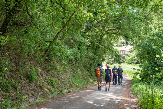 Pilgrims arriving at the Trinity Bridge in Arre. Navarre. Way of St. James. Zubiri-Pamplona Stage